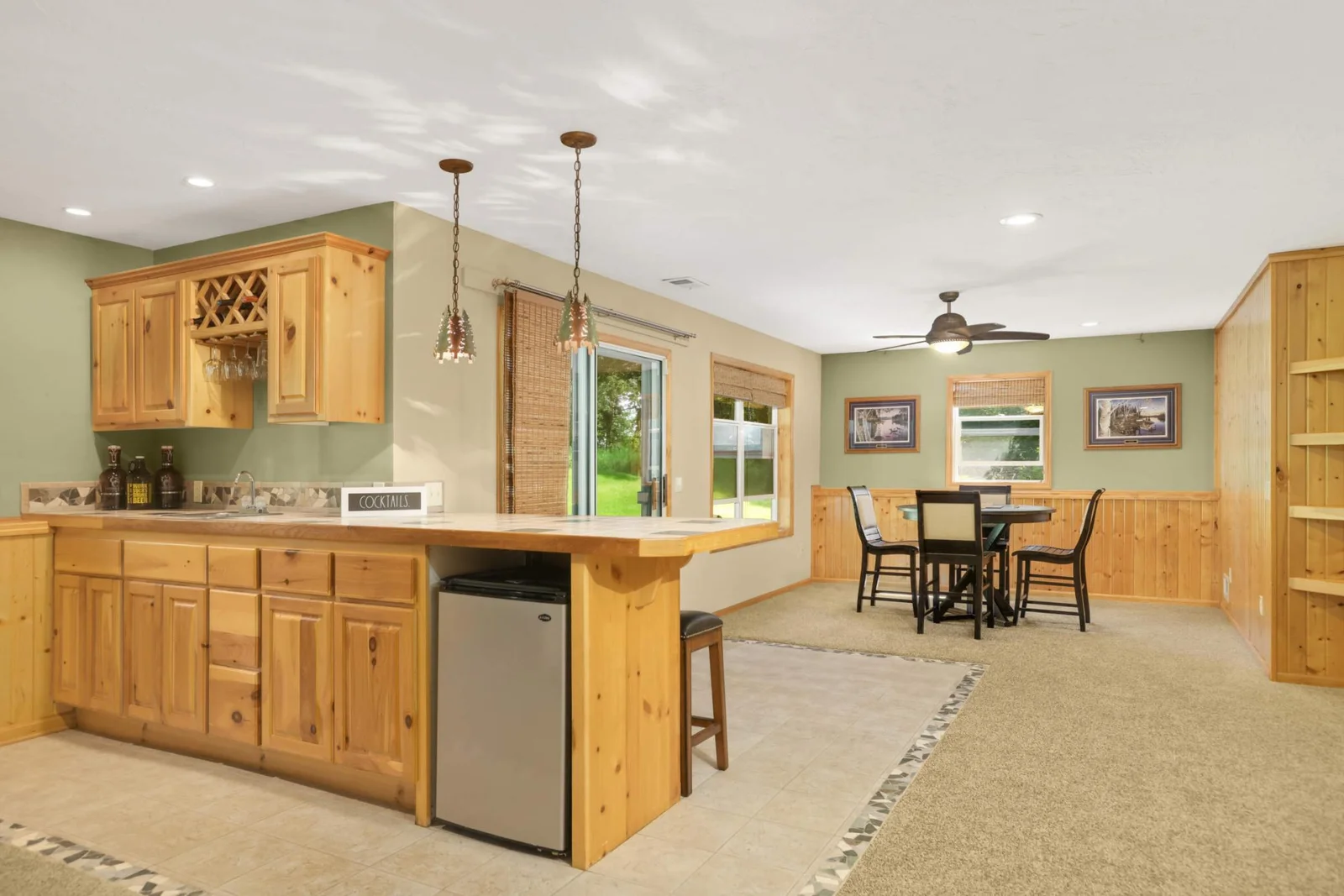 Lower-level walk-out offers a cozy gas fireplace, a stylish walk-up bar, and the perfect space for entertaining or relaxing.