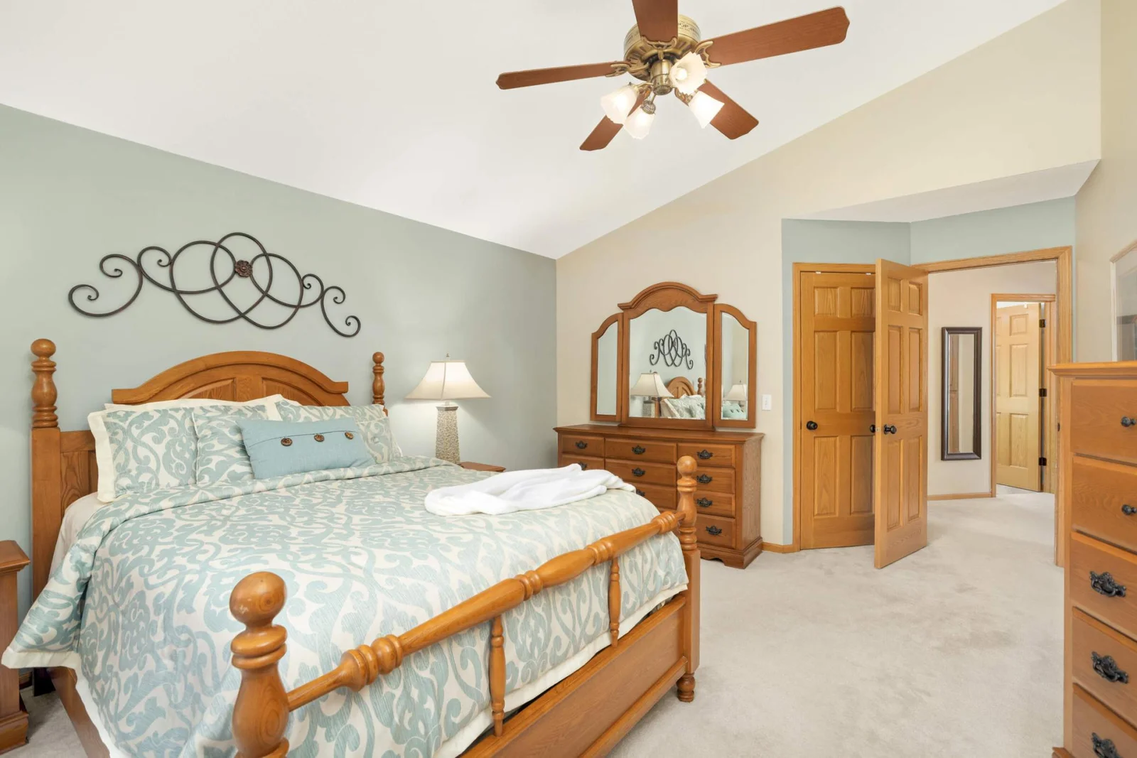 The oversized owner’s suite boasts impressive vaulted ceilings, w gleaming streams of sunlight flowing in from balcony.