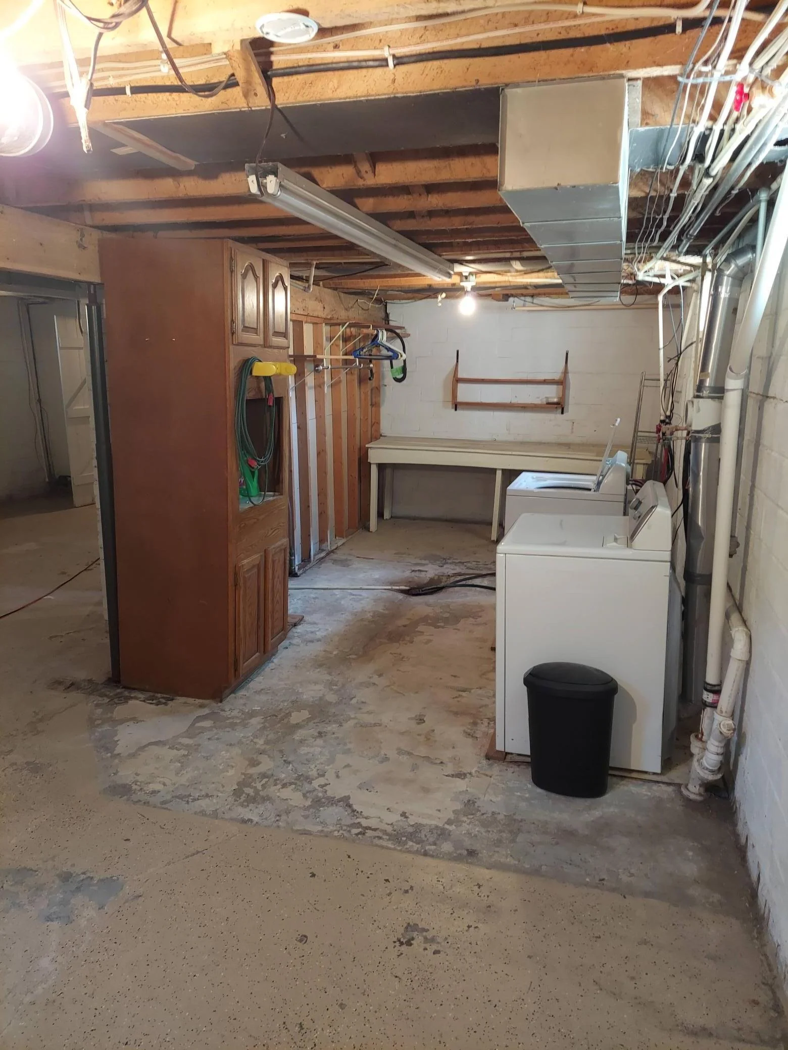 Basement laundry area with work bench