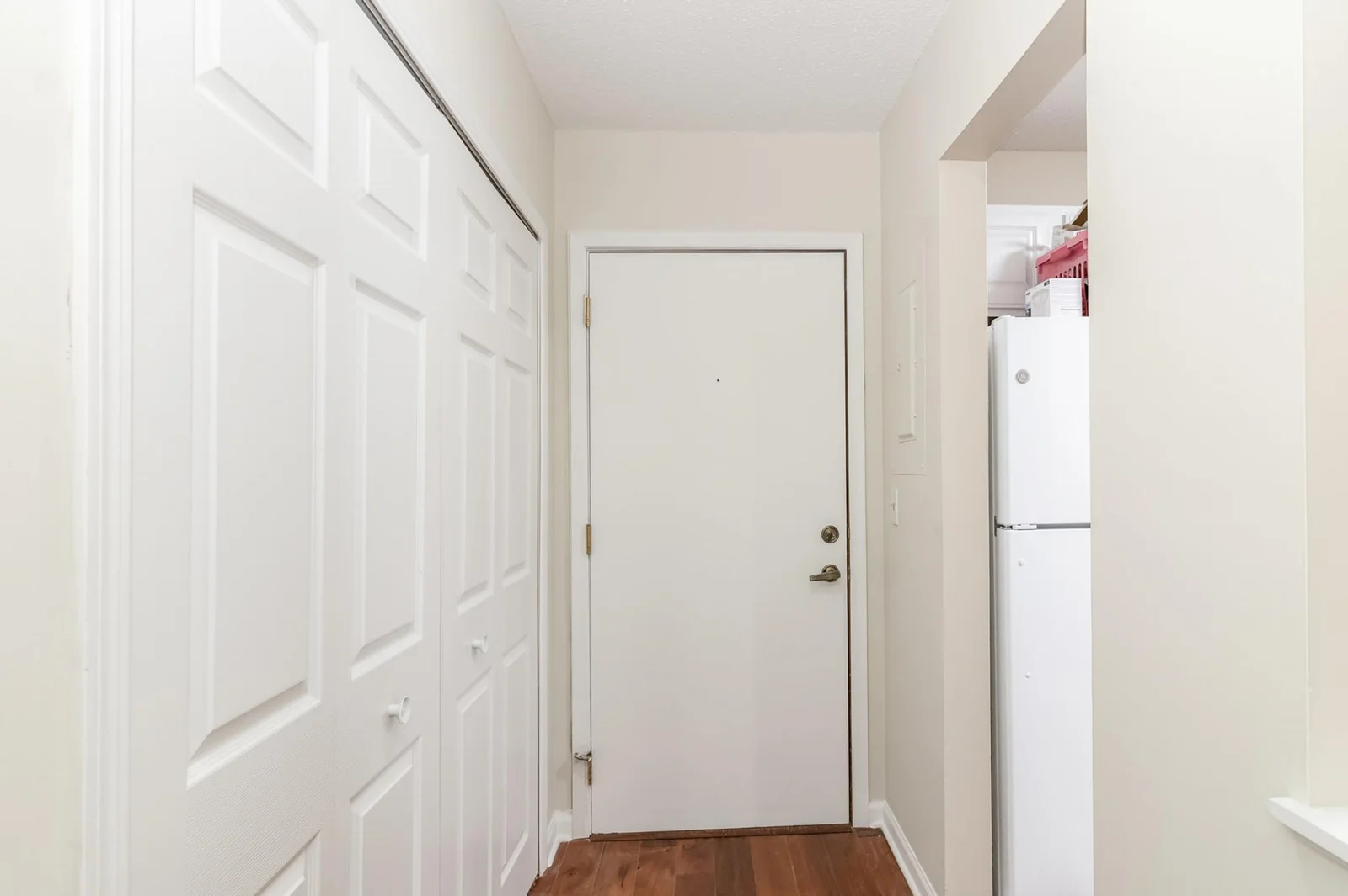 entry foyer with large coat closet and going into kitchen