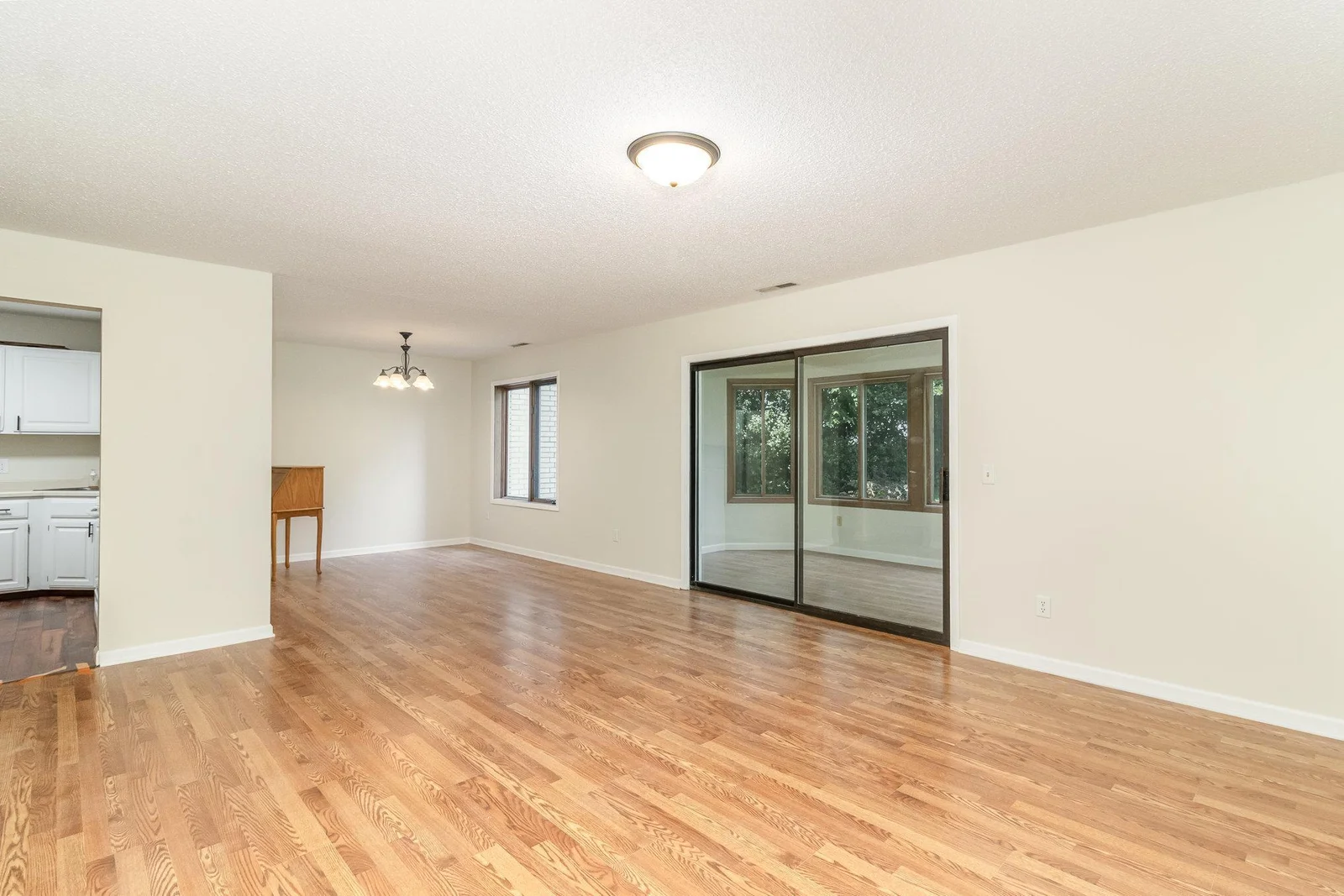 Another view of living room into dining room and porch