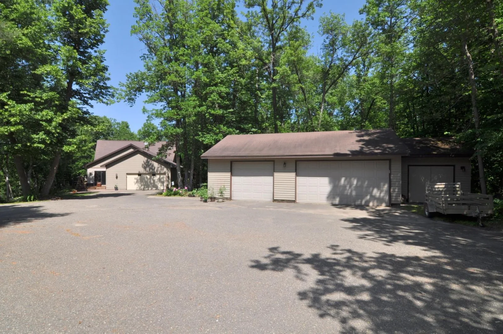 View of home with attached garage and detached garage.