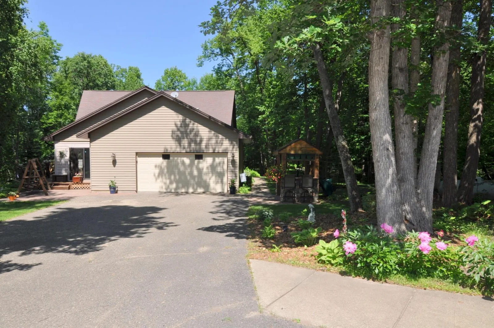 Paved Driveway leads to home with attached garage.