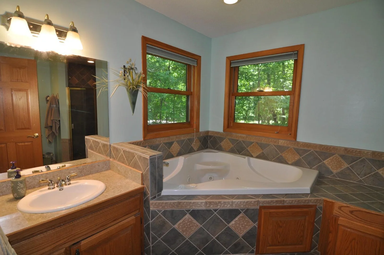Spacious primary bathroom offers a jetted tub and separate shower