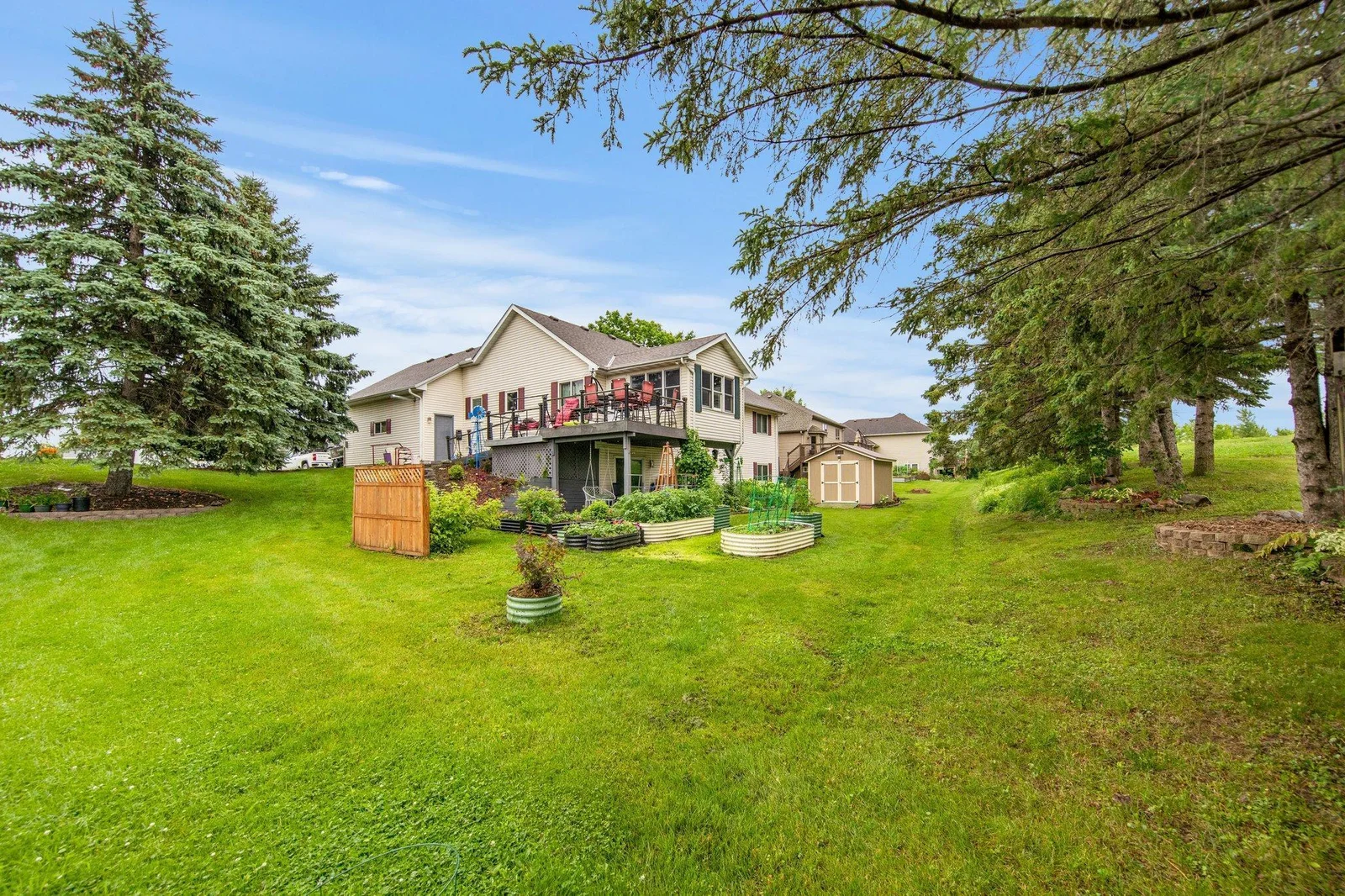 Large lot! Features a deck, patio, garden beds, and a shed!