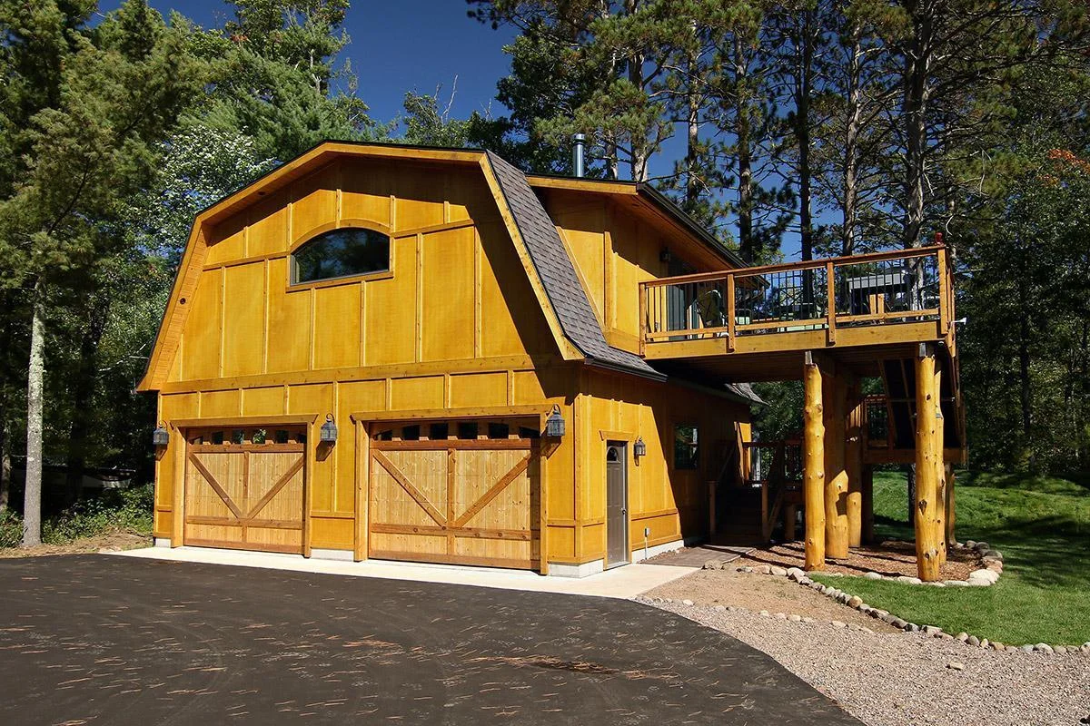 Stunning oversized garage features guest suite above with a full kitchen, bath, living space and private deck overlooking the lake