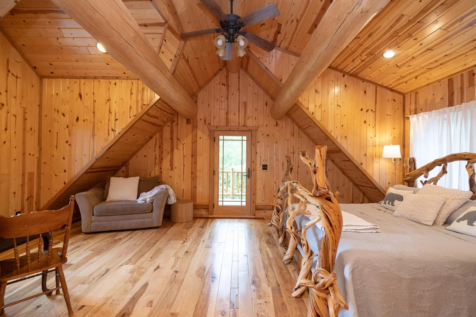 Spacious upper level bedroom with sitting area, private deck, and views of the lake