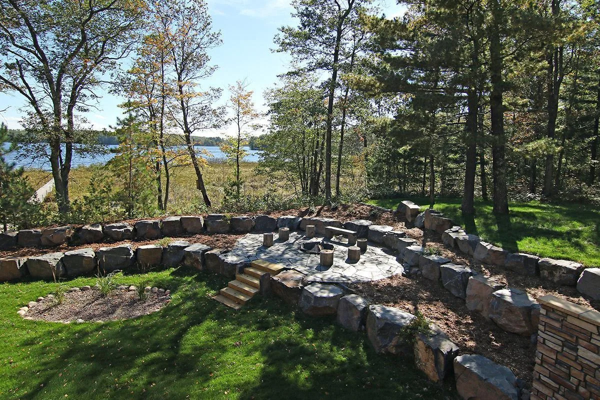 Aerial photo looking down at the elevated fire pit area complete with bolder retaining walls