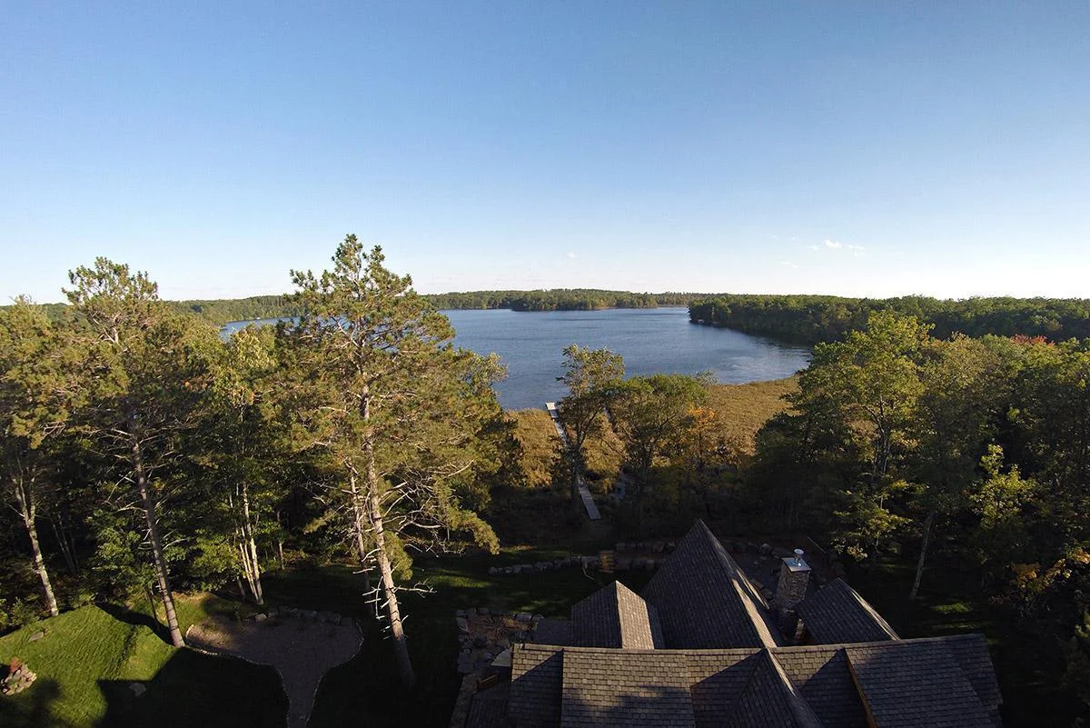 Aerial drone photo from behind the home looking towards the lake
