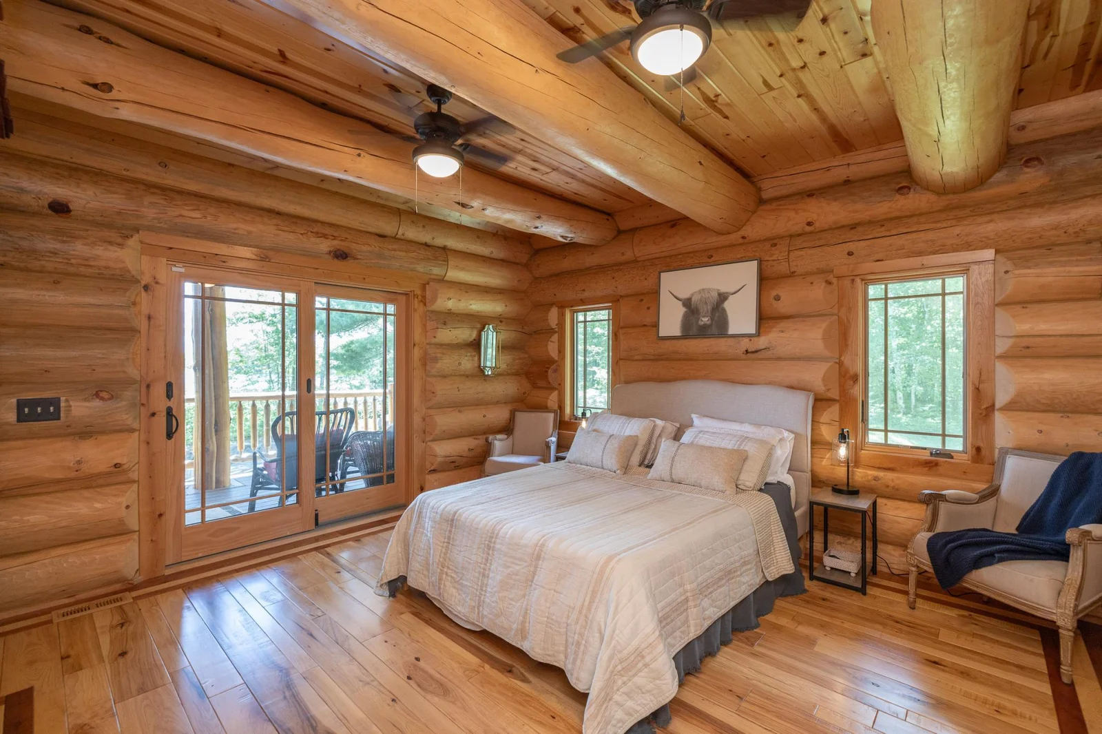 Main floor primary bedroom with private deck overlooking the lake
