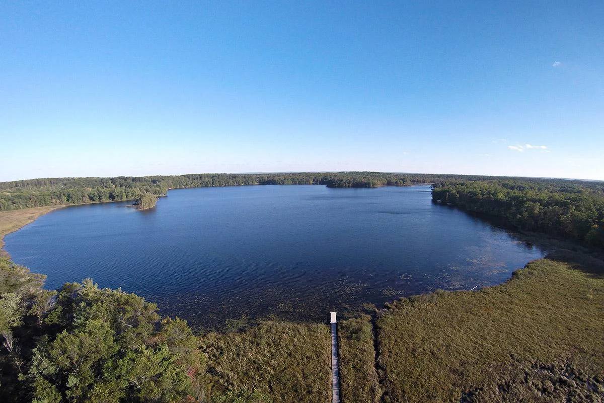 Aerial drone photo from above the home looking over the lake