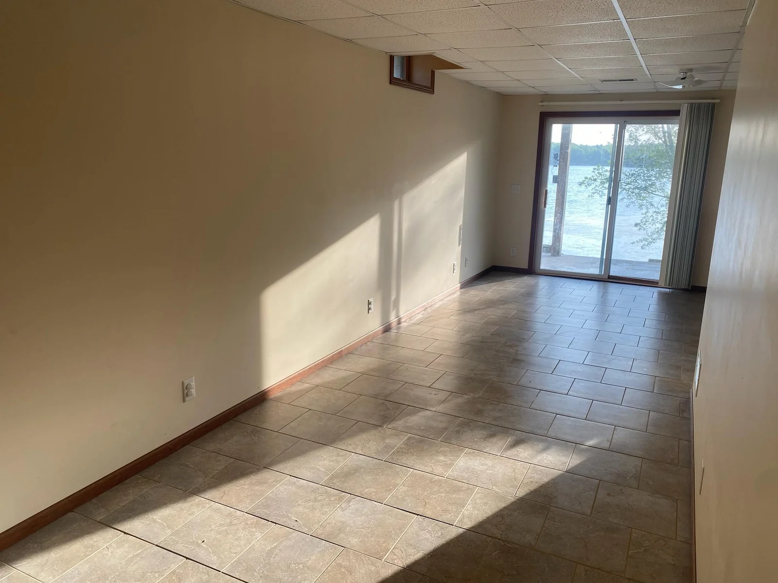 Lower Level Family Room has tile floors and two walkouts to the patio and lake front