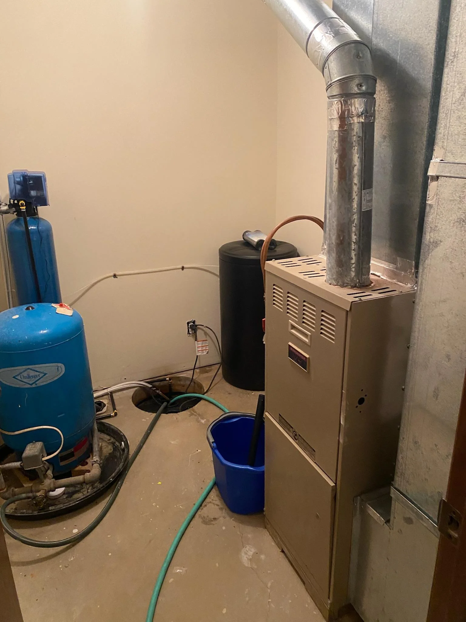 Mechanical Room with water filtration system, water softener and sump basket. Located in lower level. Controlled by hall thermostat in lower level.
