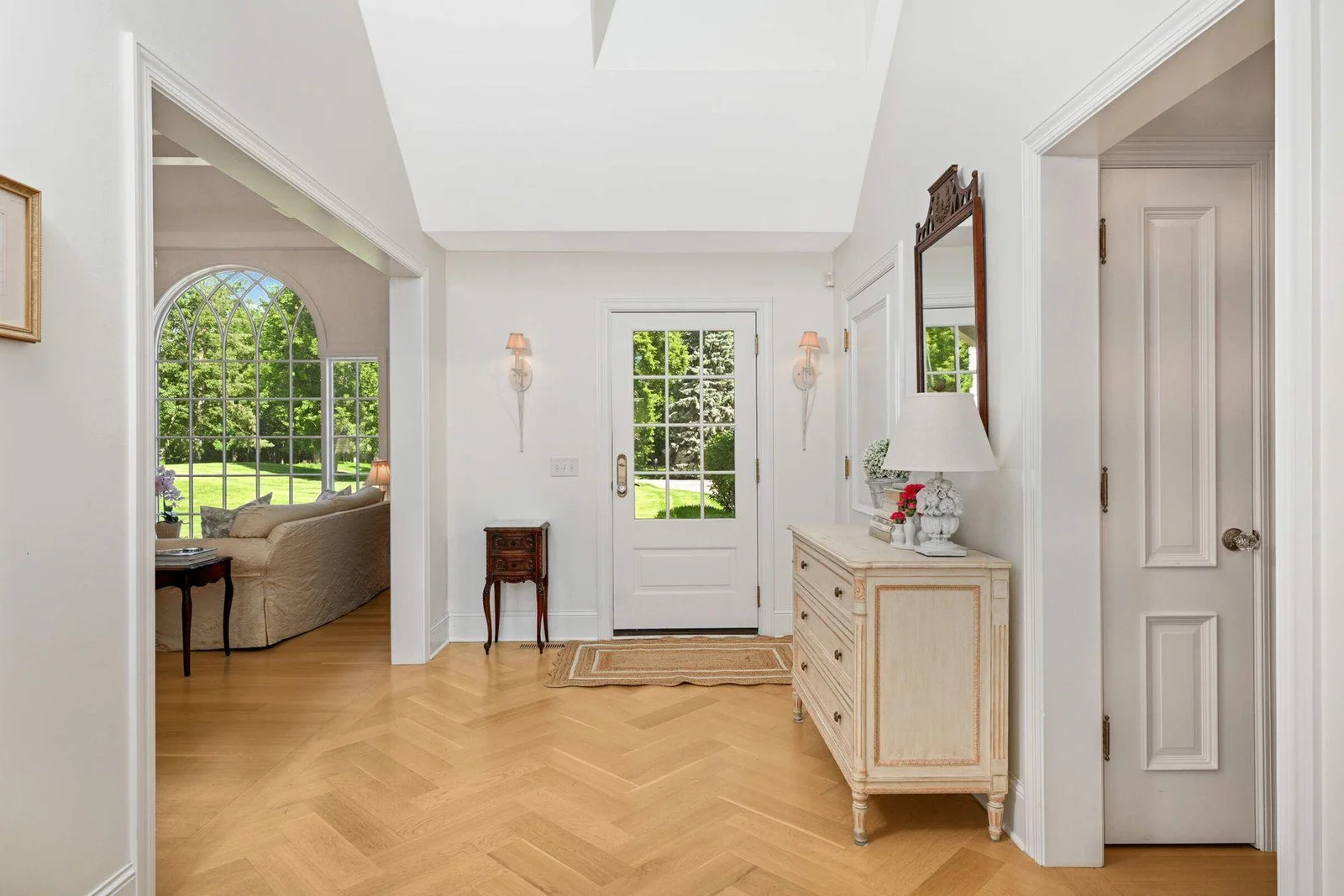 The foyer is vaulted with a charming "eyebrow" dormer window, and leads to the impressive common living spaces.