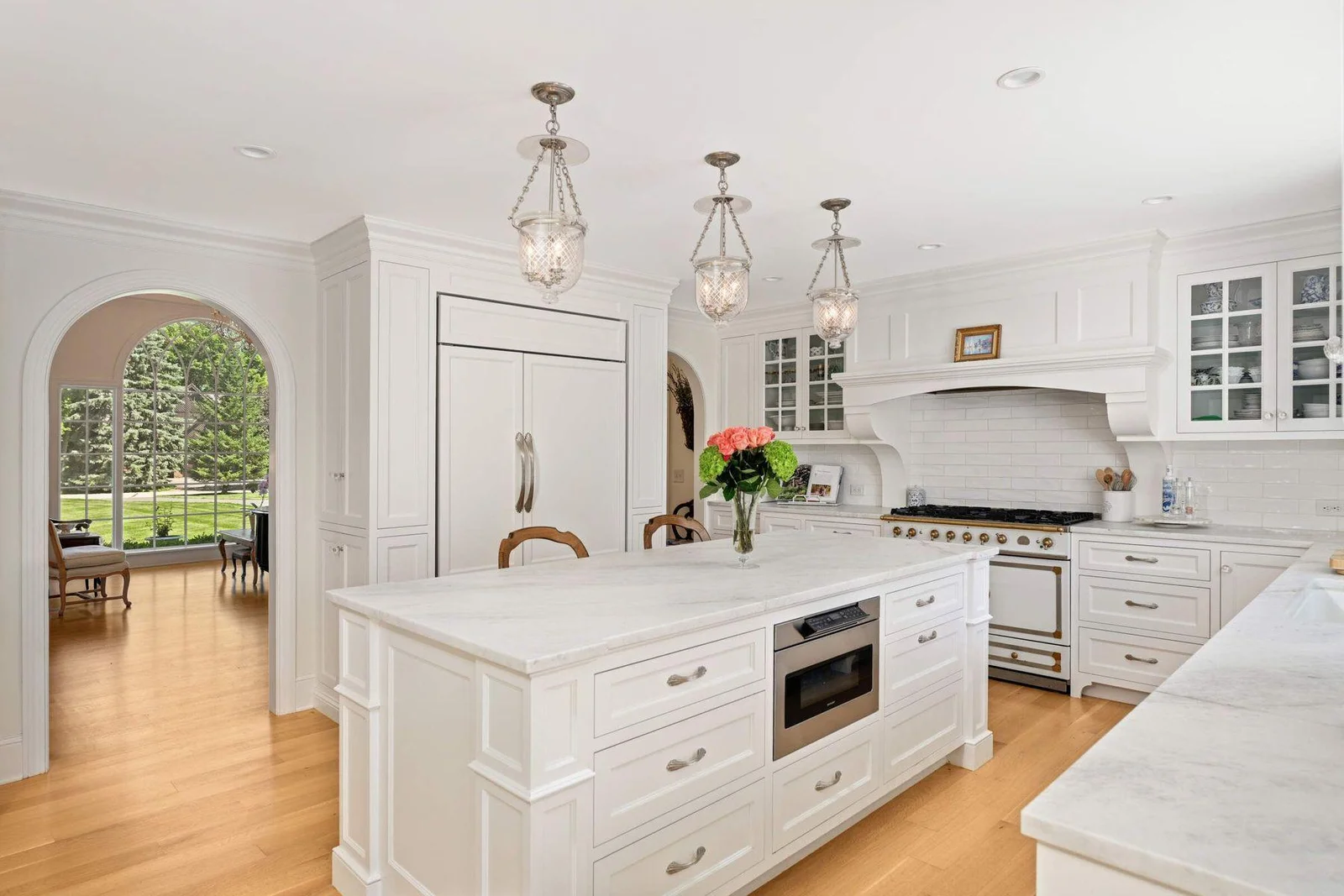 The Subzero refrigerator is flanked by two pantries on either side, exceptionally designed to be European and less "suburban".