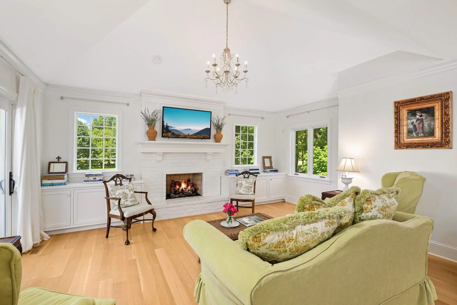 The family room has been thoughtfully enhanced with new windows on either side of the fireplace, which was once built ins. The lower cabinets still provide plenty of pull out cabinet storage.