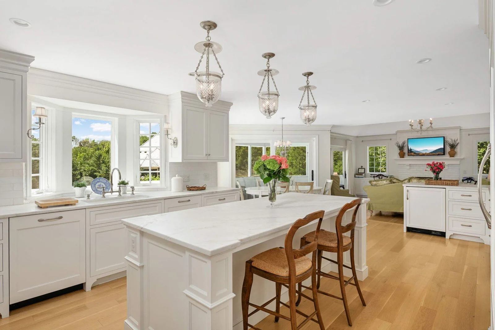 Off the kitchen there is a bar area with extra glass display shelves for barware, the breakfast area, porch and family room.