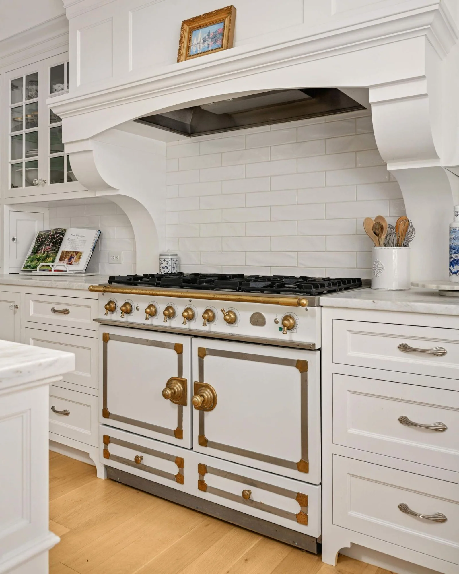 The 42" La Cornue range is dual fuel and features double ovens (one convection), and stainless and brass hardware with patina finish.