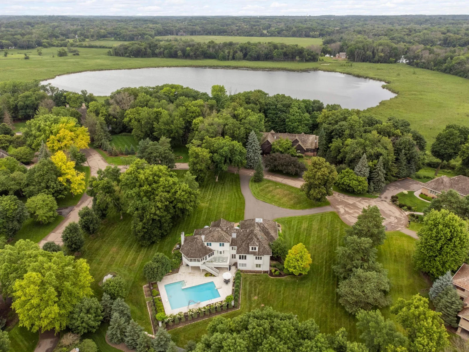 French Lake is visible from the front of the house, and very little emphasis on neighboring properties.