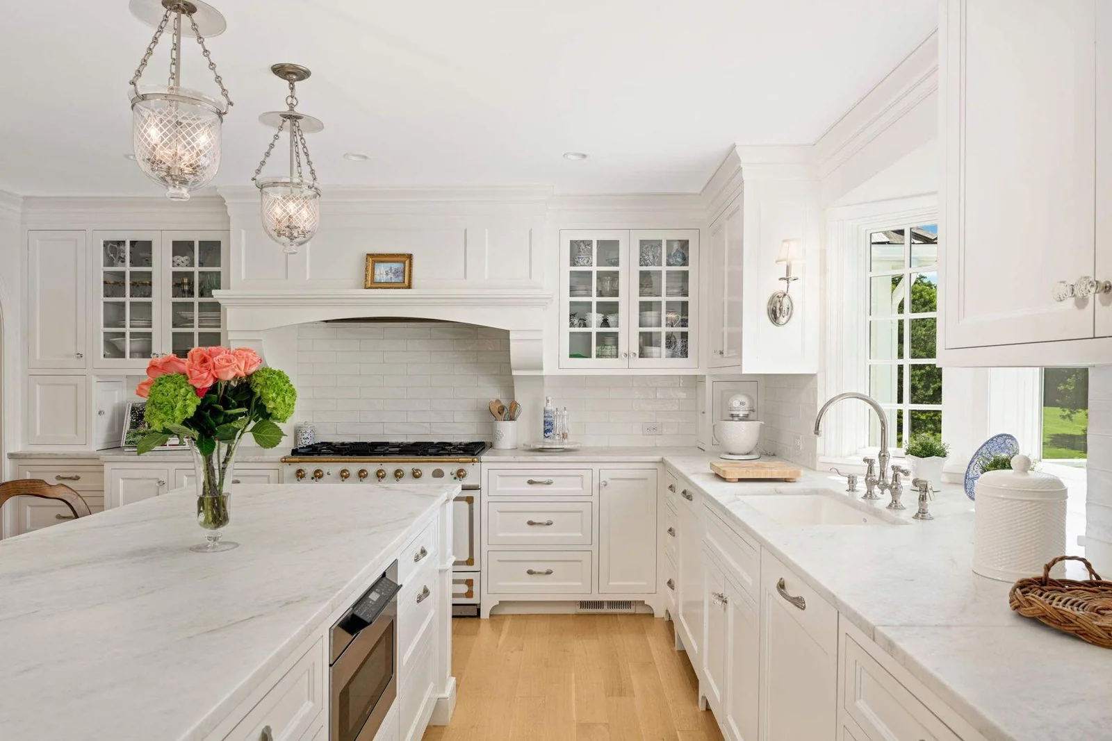Behind the island is the pull out microwave, neatly stored, two dishwashers and beautiful lighting fixtures.