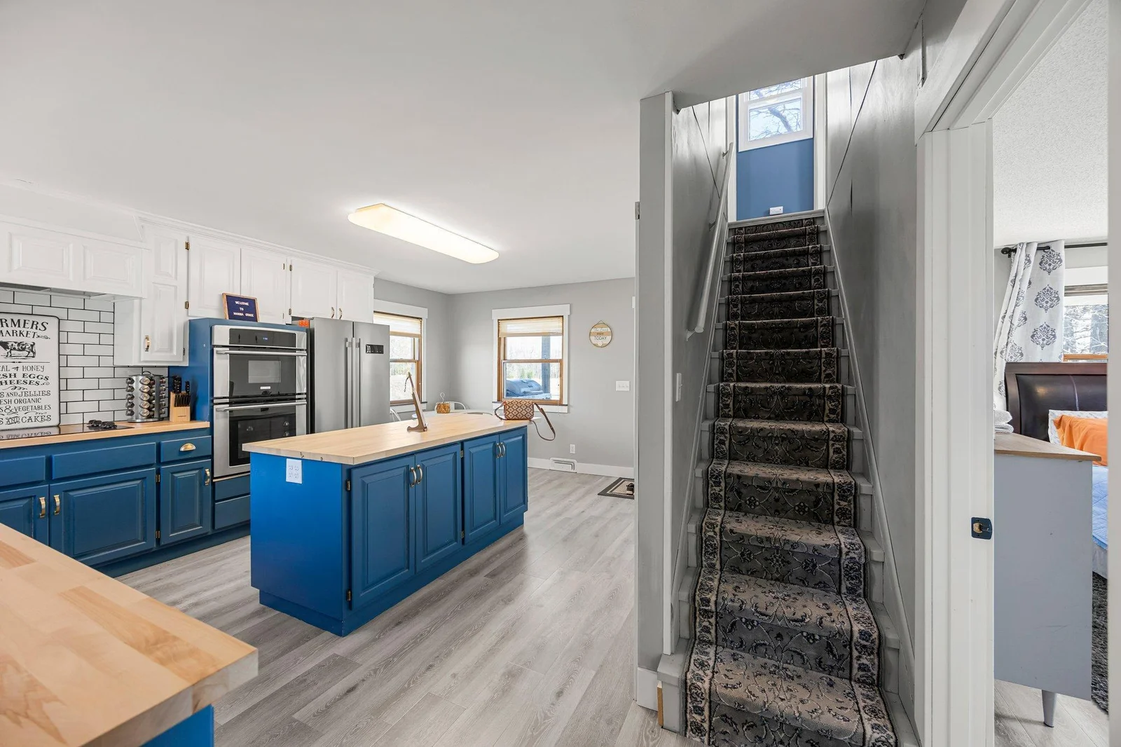Stairway off kitchen to upper level bedrooms.