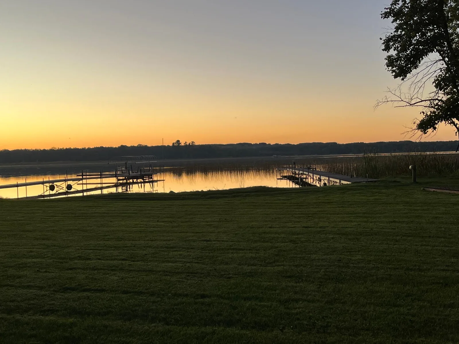 The owner's pictures with their dock in (they're dock is on the right and their property line is about 2 feet to the right of the electrical pole).