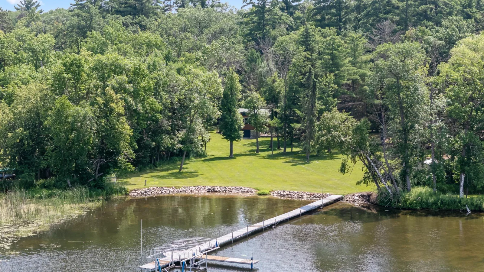 Stunning lot with a gradual slope to the shore. Plenty of room for all your yard games! (dock shown is neighbors)