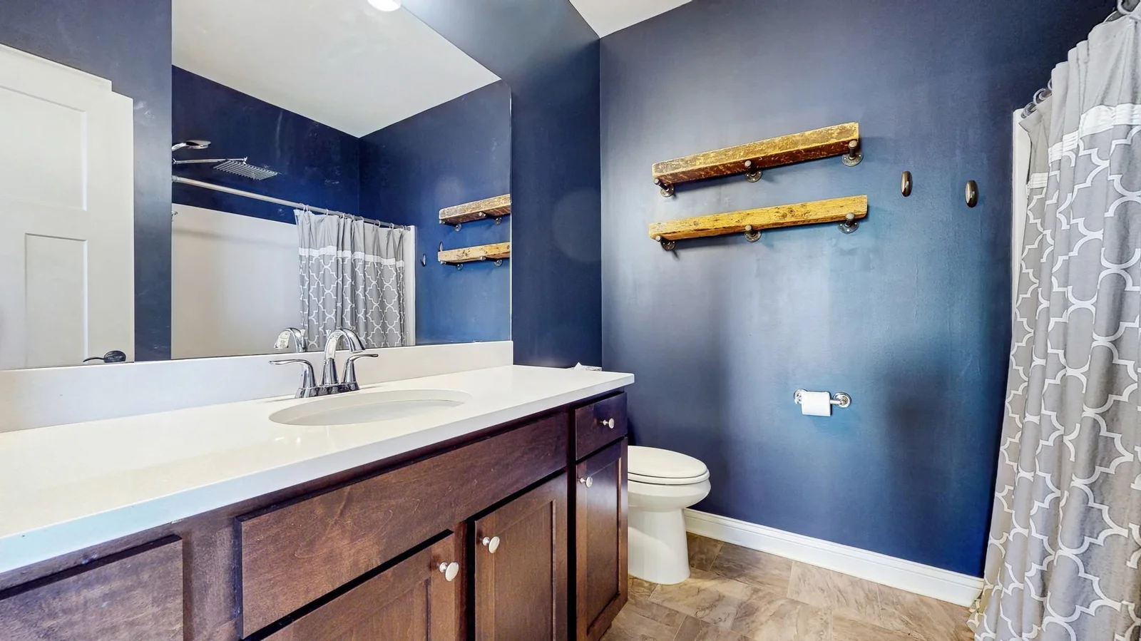 The upper full bathroom has a large vanity and linen closet behind the door.