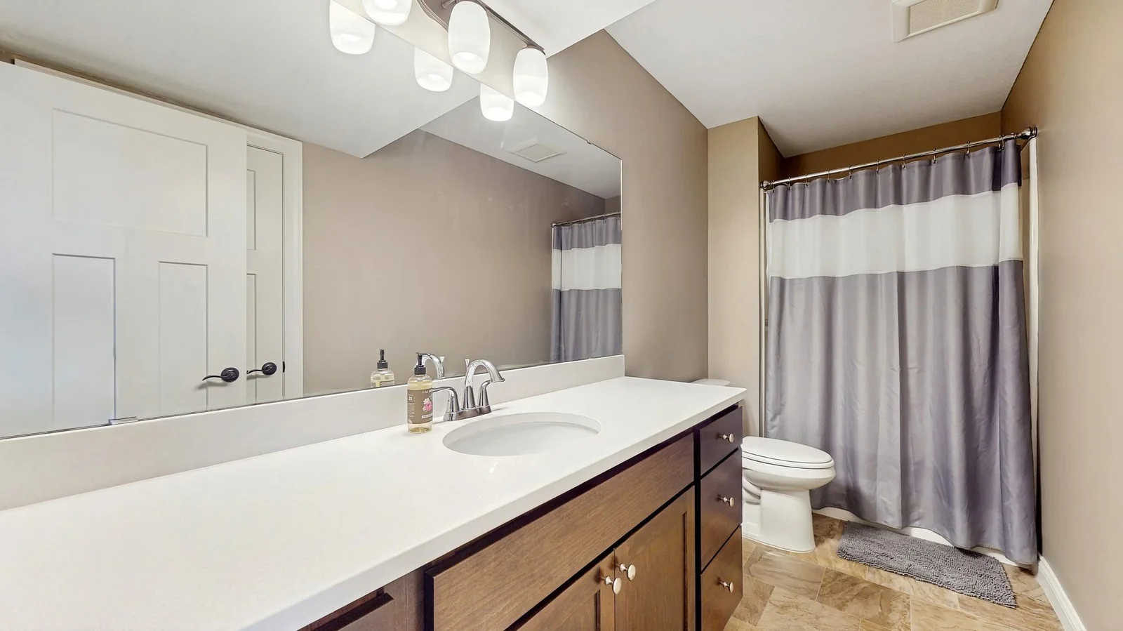 Lower level bathroom is spacious and has plenty of counter space.