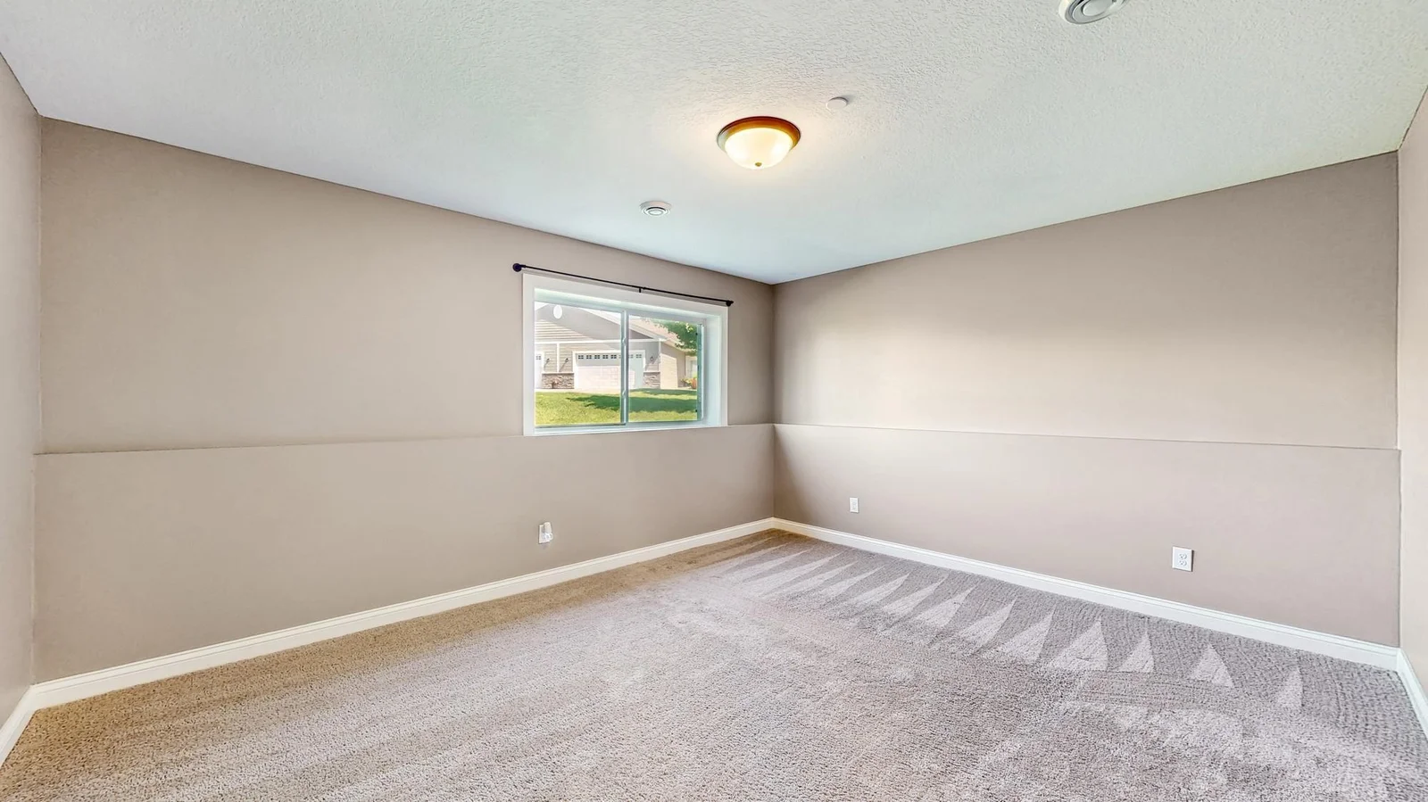 The lower level family room has a window providing natural light.