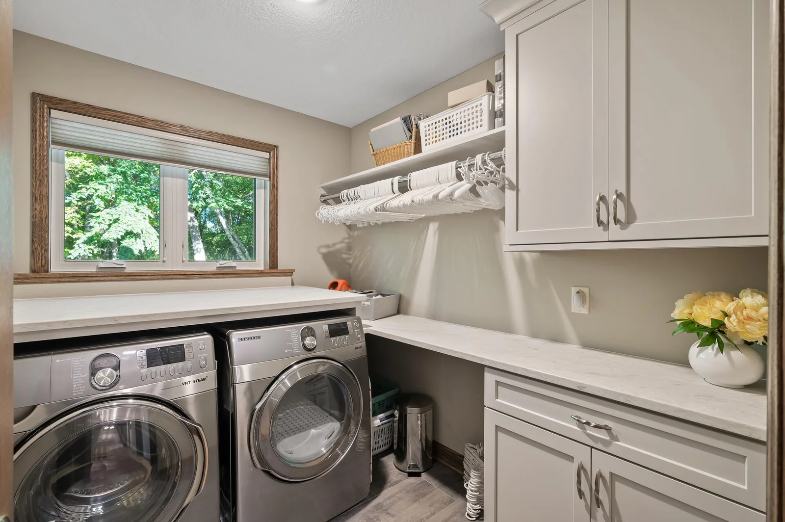 Main level remodeled laundry room with storage and counter space for convenience!