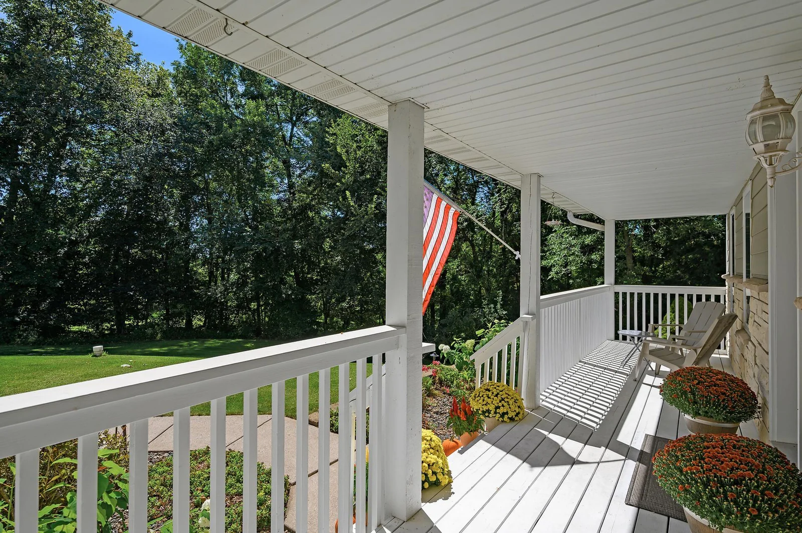 Welcoming front porch with custom landscaping in front.