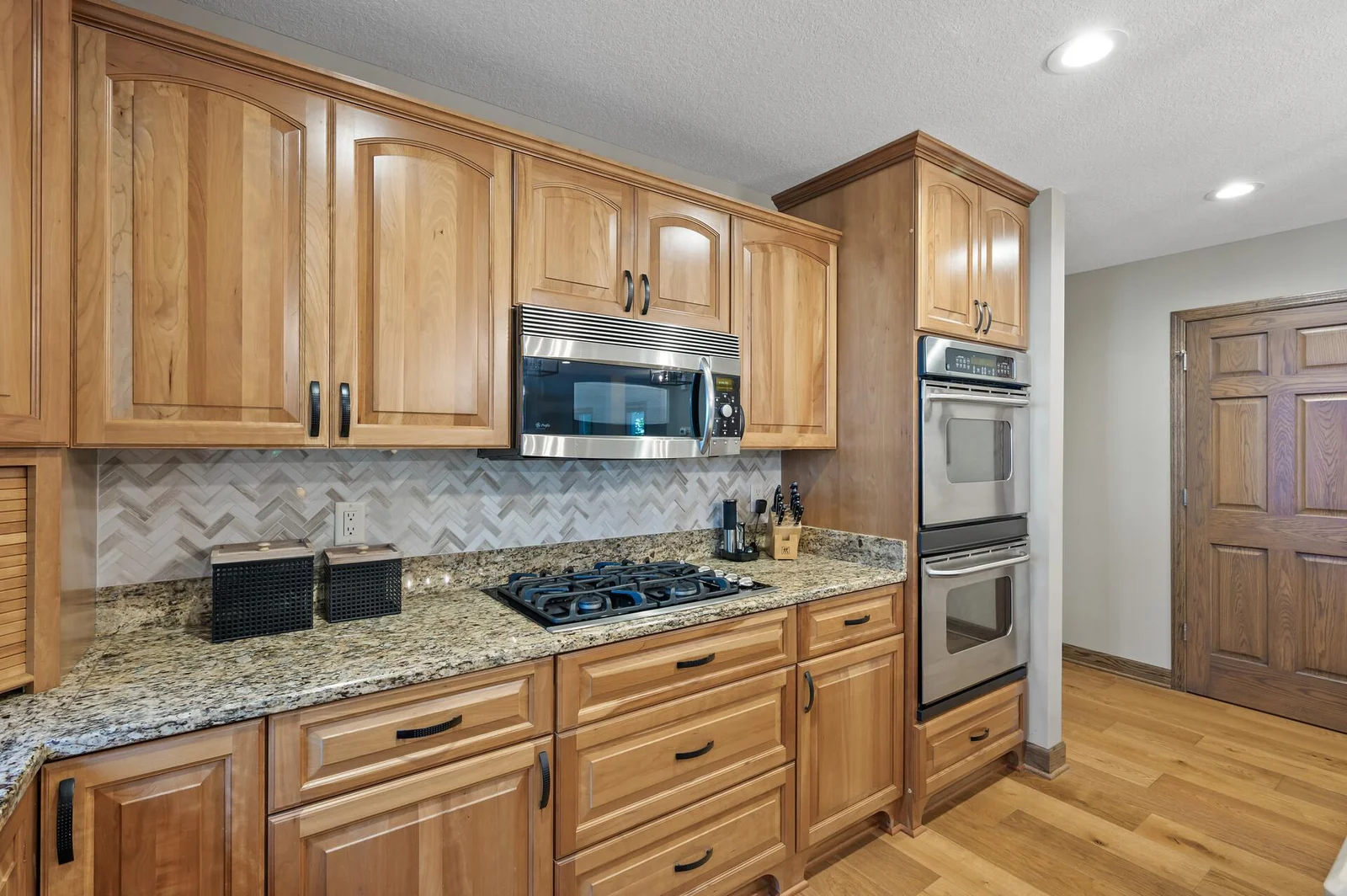 Dual ovens, gas top range and stainless appliances.