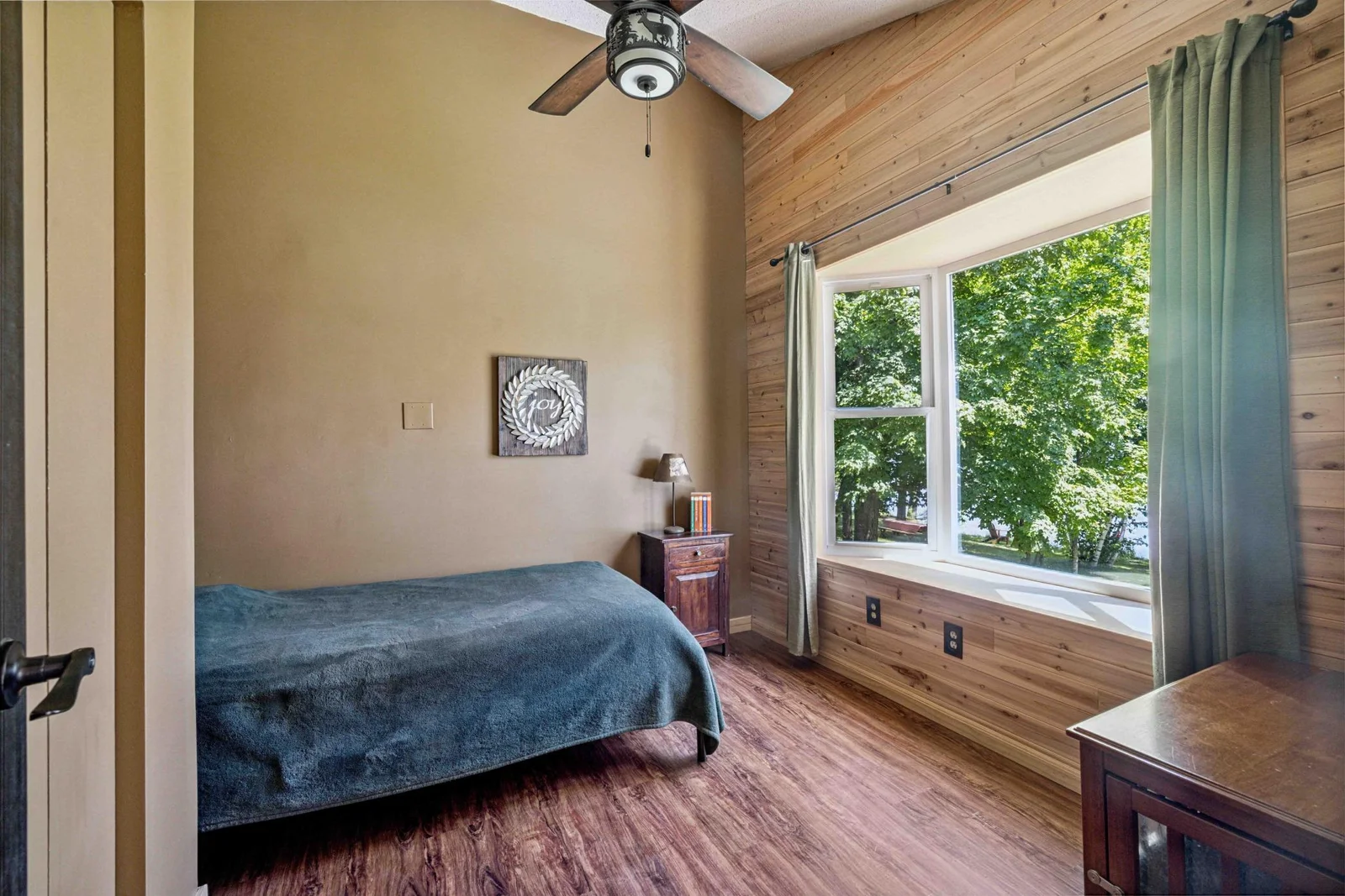 Main level bedroom 2 with bay window views