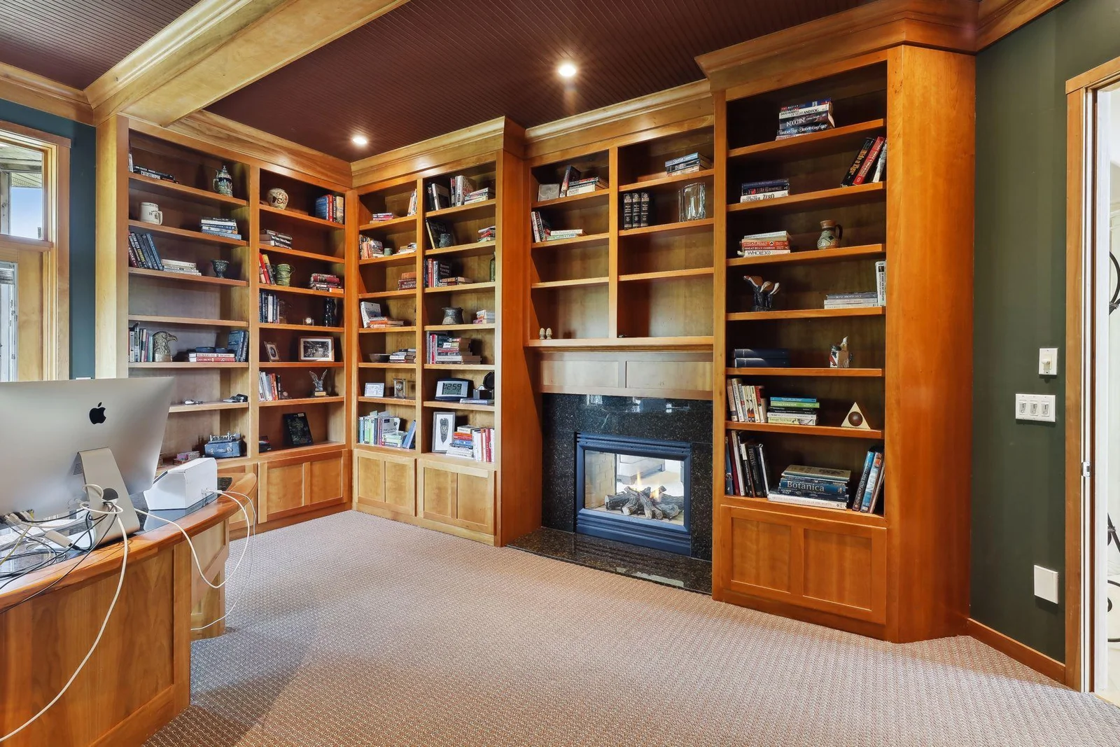 Custom office built-ins with an abundance of storage and shelving space for books, decor, pictures and more! Double sided fireplace for those chilly nights and work days!  What a perfect setup to work or run your business from home!