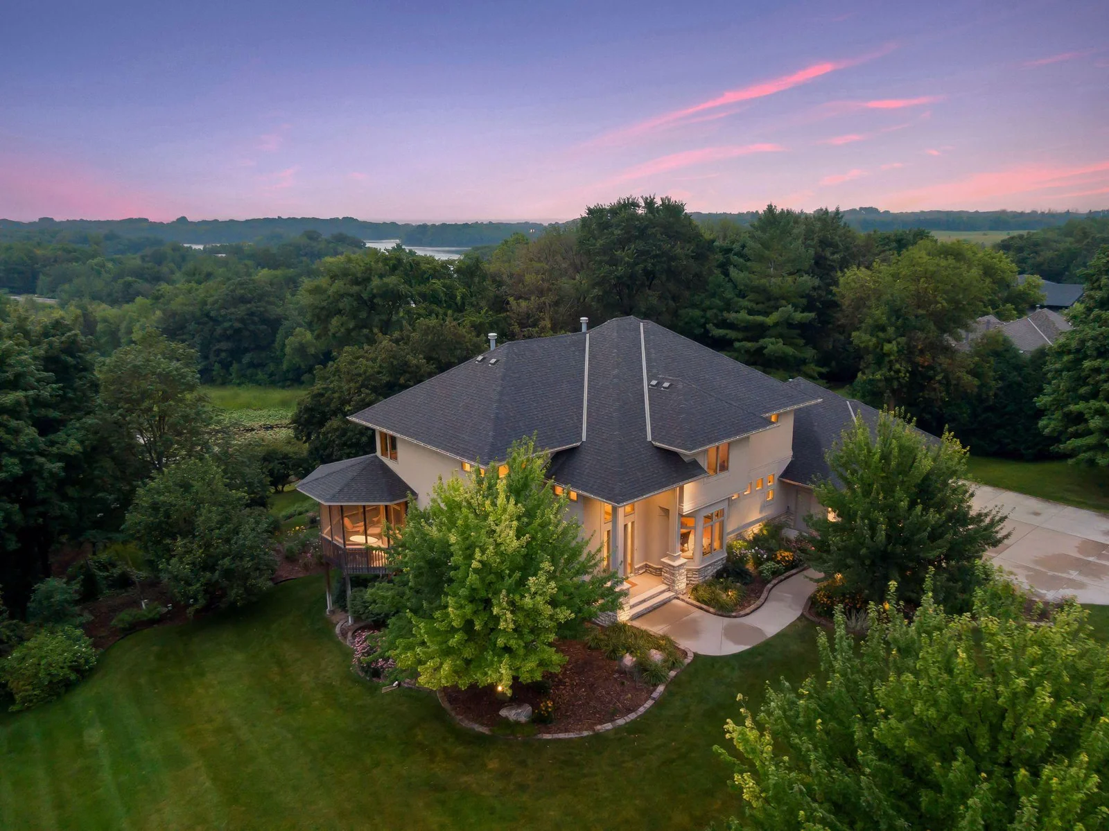 Absolutely gorgeous curb appeal nestled on a fabulous, .87 acre lot! Custom built, stylish, modern window and stone accents, beautiful mature trees along the serene lakeshore on a fabulous south metro recreational/fishing lake.
