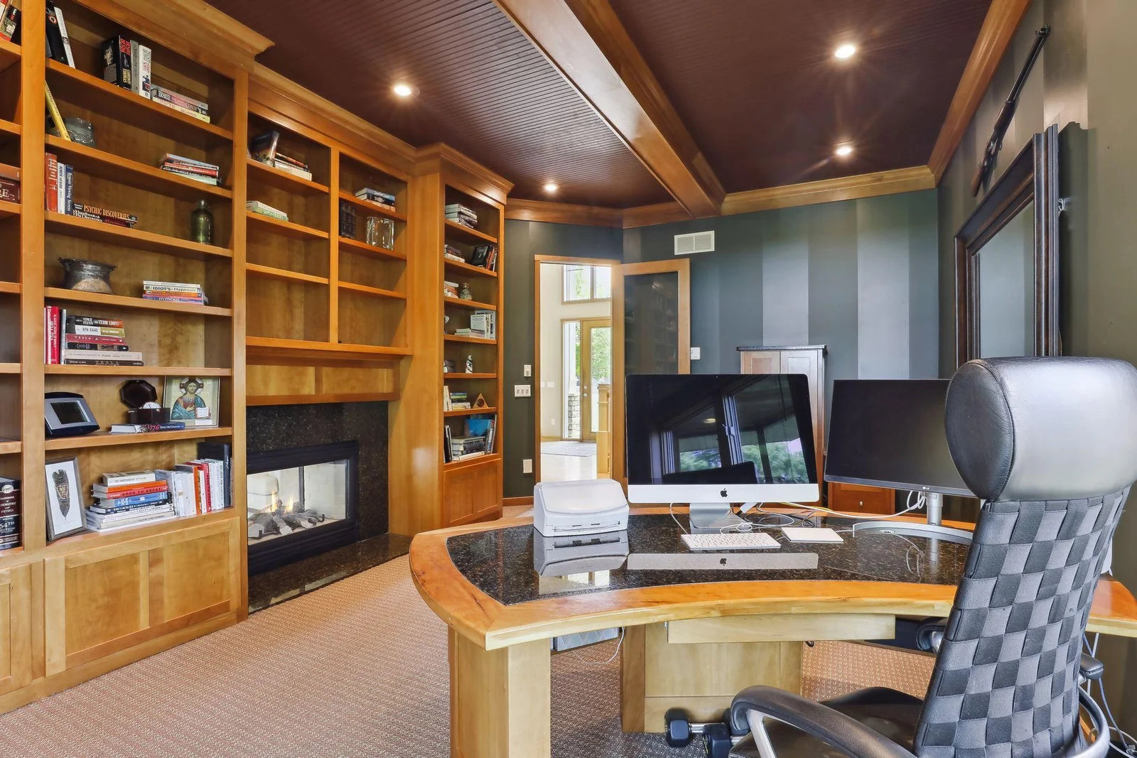 Enjoy a relaxing work space w/ the 2-sided fireplace! No shortage of built-ins. Beautifully, custom shelving and cabinetry throughout.