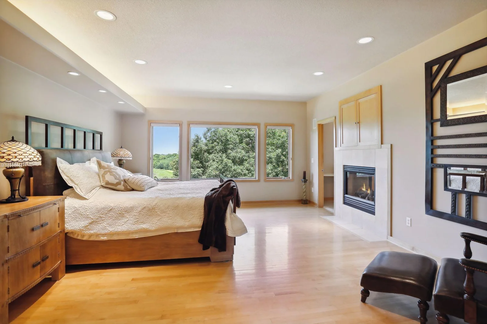 Retreat to this glorious owners suite. Expansive windows with private, lake views! Double sided fireplace shared with luxurious, primary bathroom!