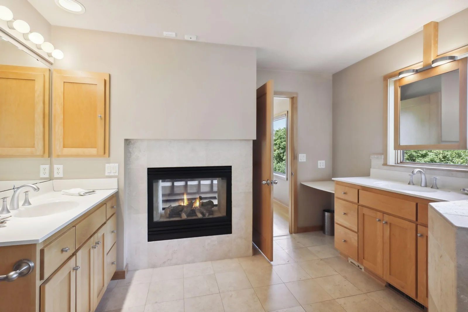 Cozy, double sided fireplace shared with luxurious, primary bedroom. Dual vanities offers fantastic, separated space and abundance of storage for all the accessories.