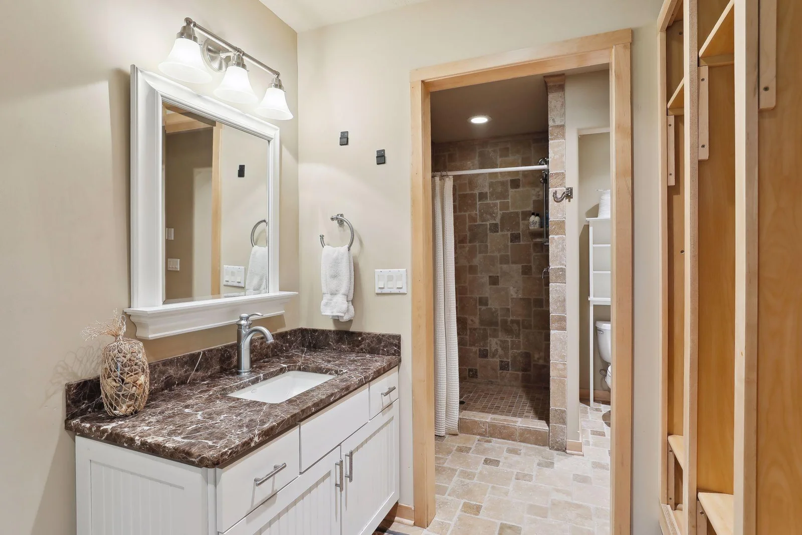 Super convenient lower level 3/4 bathroom w/ beautiful tiled shower and fabulous lockers space beach towels! Home was built for lake days!!