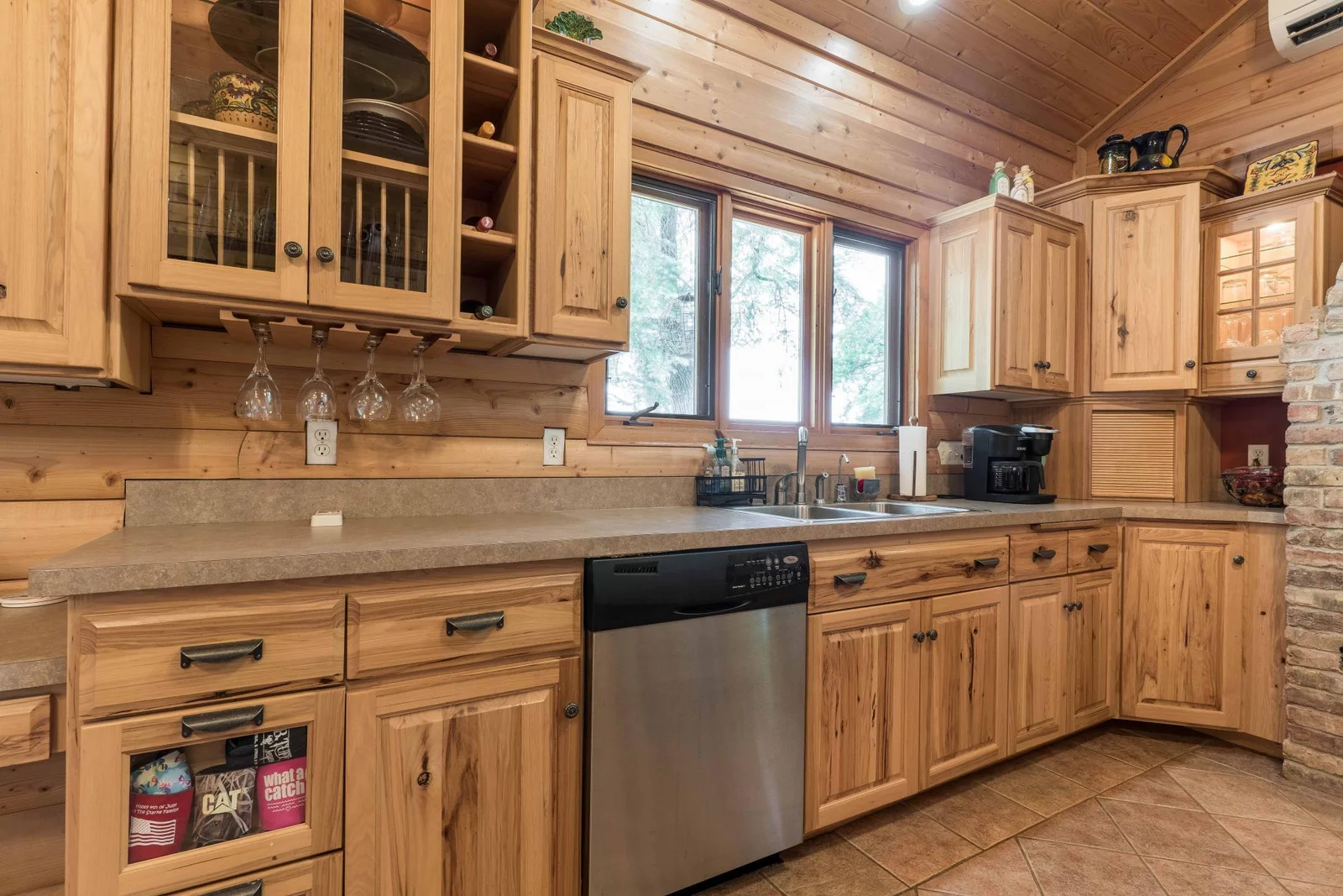 lots of cabinets with windows over sink.
