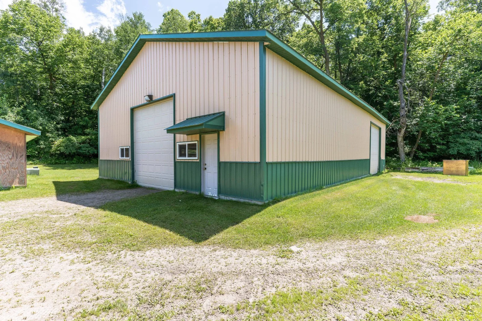 60' X 40' Pole shed with 12' doors this shed has  2 12' doors and one 8' for height and a service door with awning Built in 2003