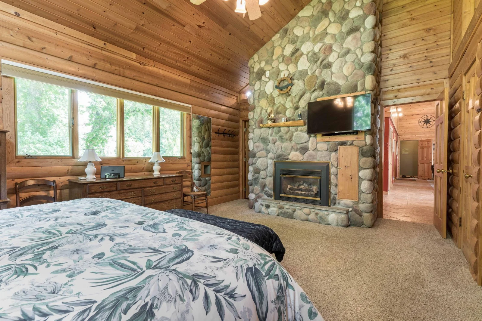 Master suite complete with floor to ceiling stone fireplace,