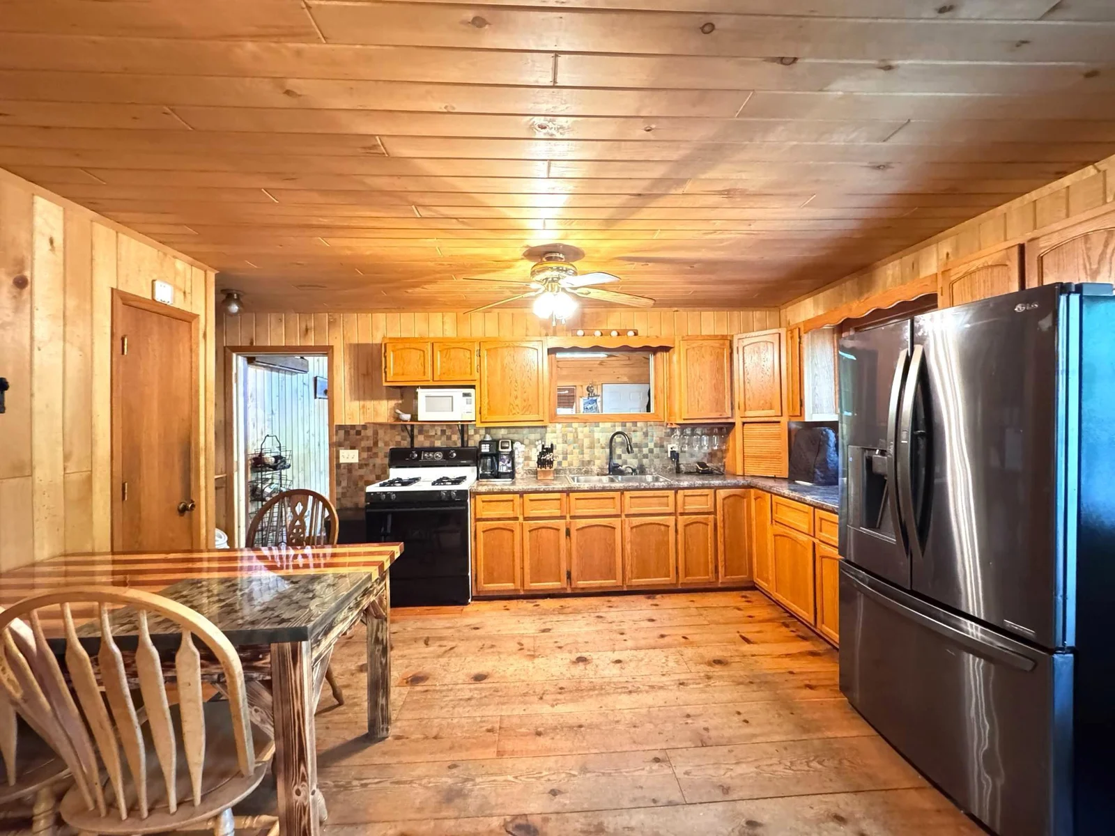 Kitchen and dining. Opens up to the 3 season room.jpg