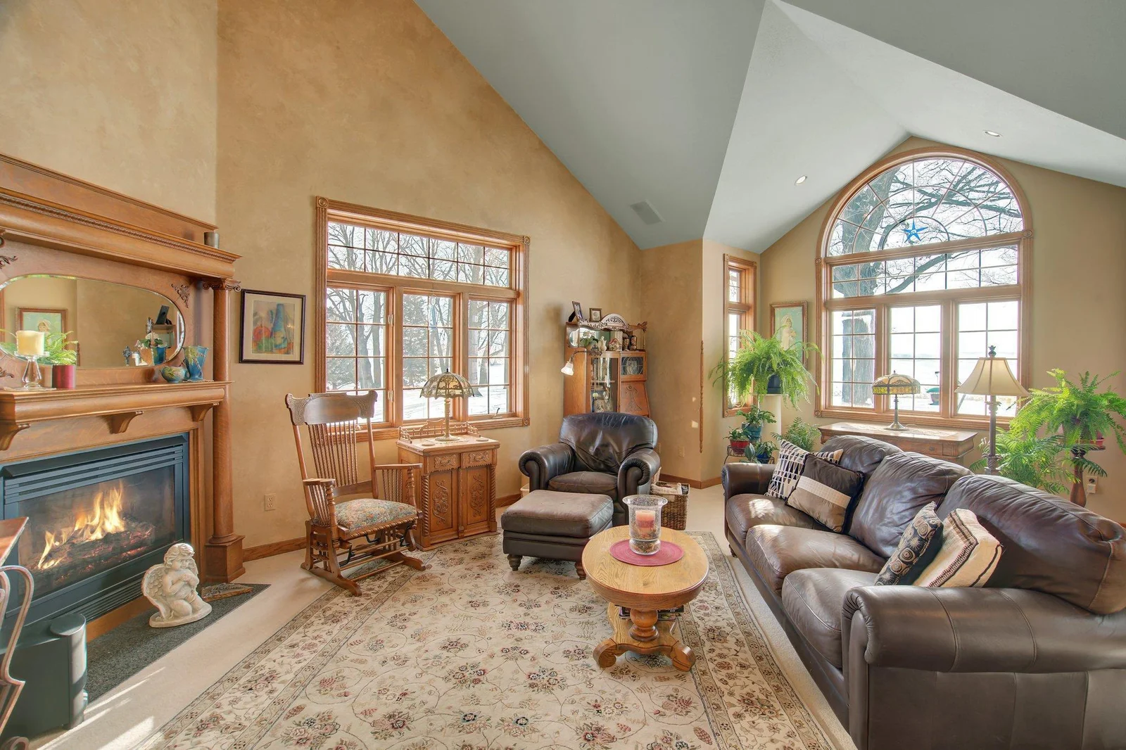 Two-Story Living Room with Gas Fireplance and oversized windows