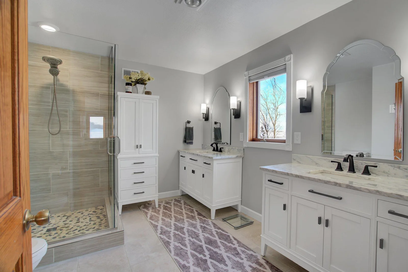 Renovated Primary Bath with double sink vanities, storage, and oversized custom shower