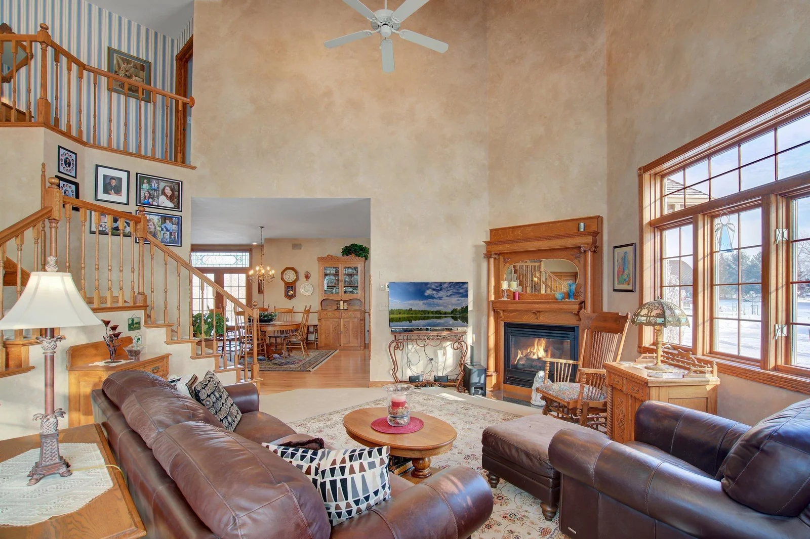 Two-Story Living Room with Gas Fireplance and oversized windows
