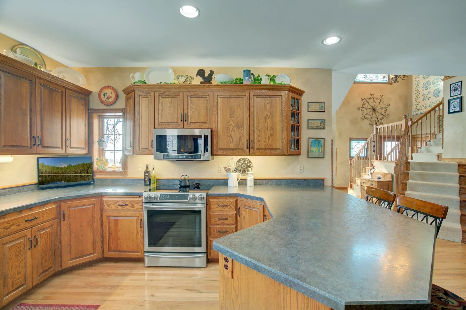 Custom Kitchen with solid wood custom cabinetry and eat-in peninsula bar
