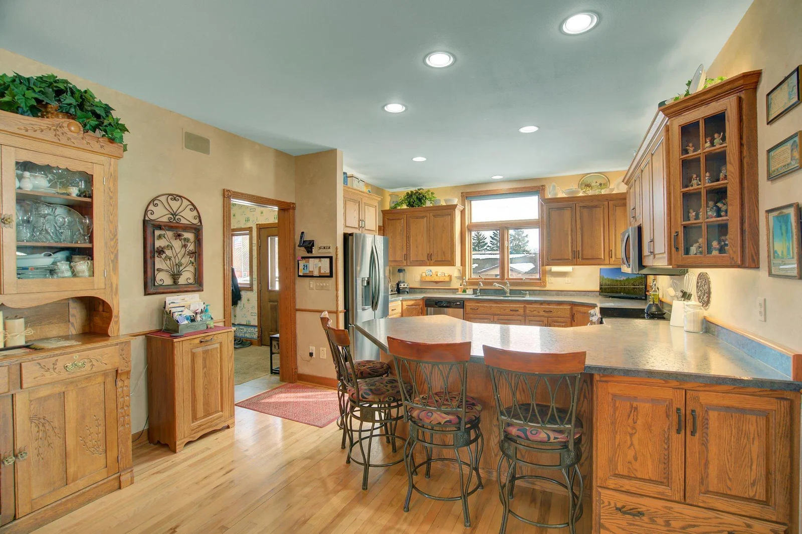 Custom Kitchen with solid wood custom cabinetry and eat-in peninsula bar