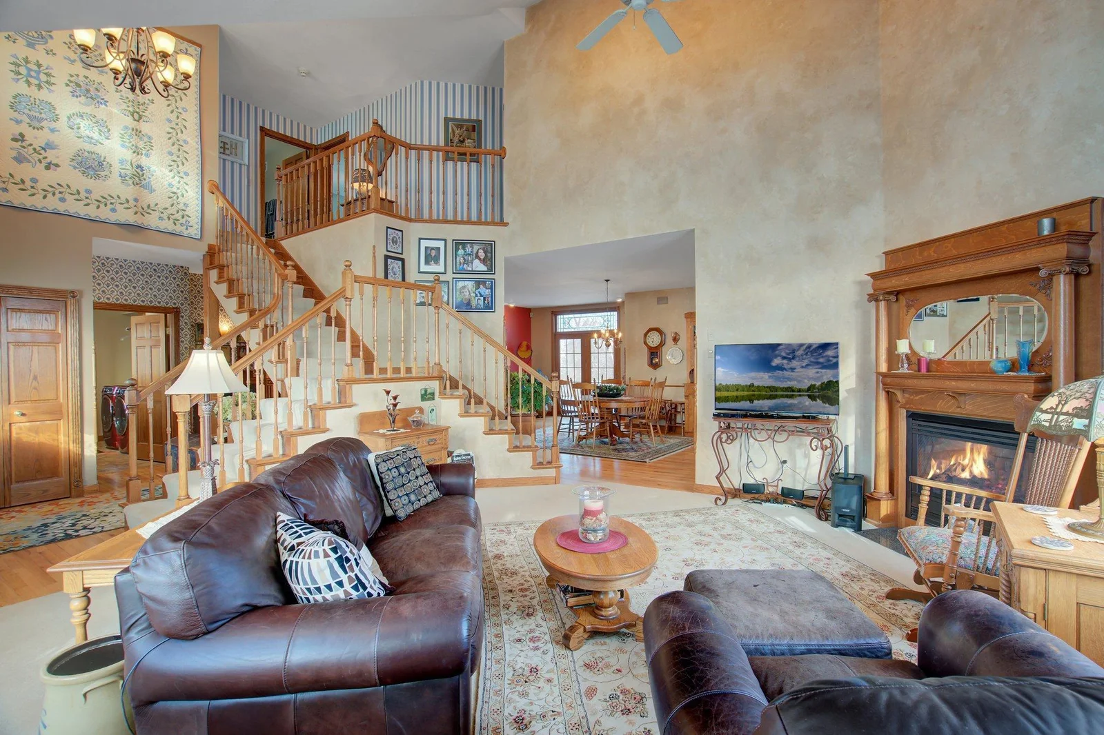 Two-Story Living Room with Gas Fireplance and oversized windows